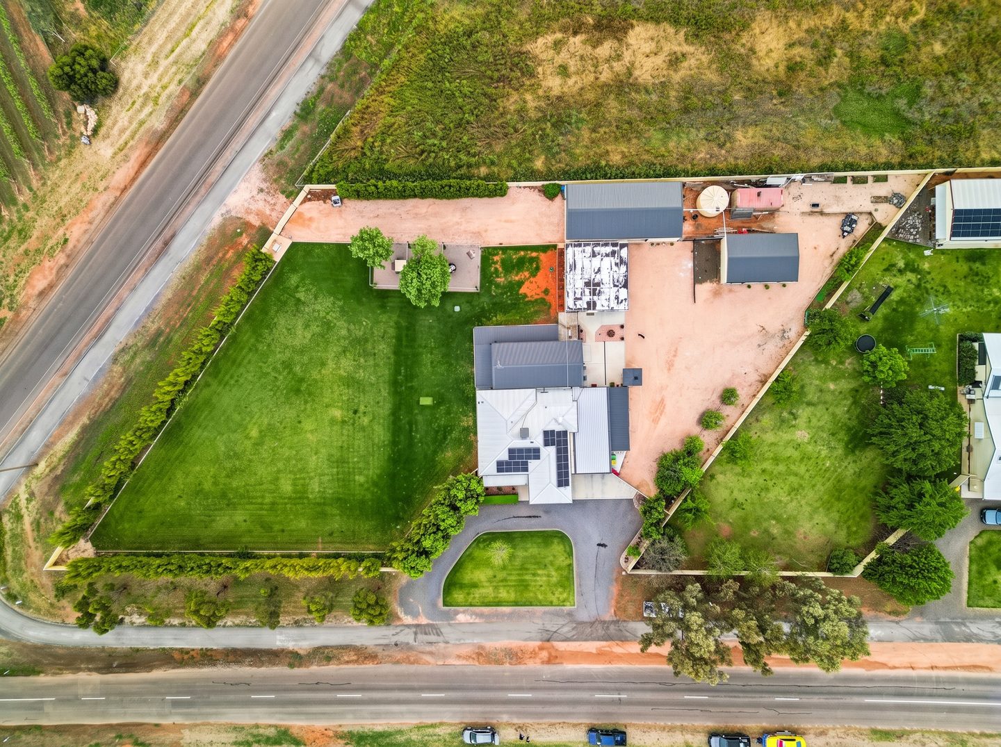 Overhead view of the residence, bungalow, gardens and shedding