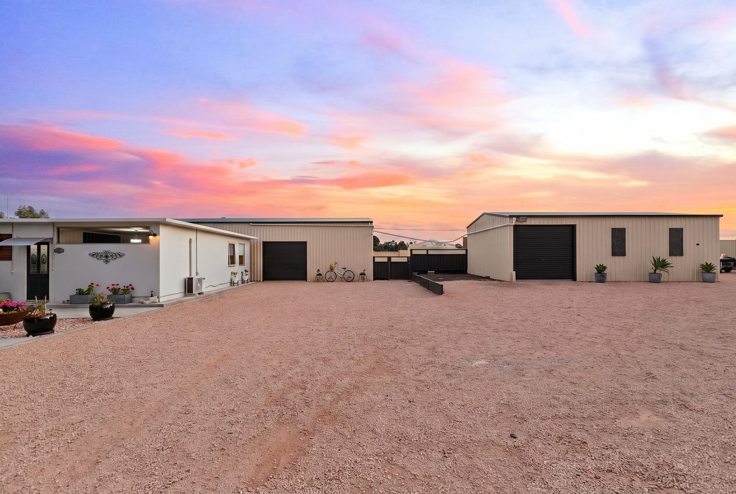 Shedding and bungalow around the broad gravelled area